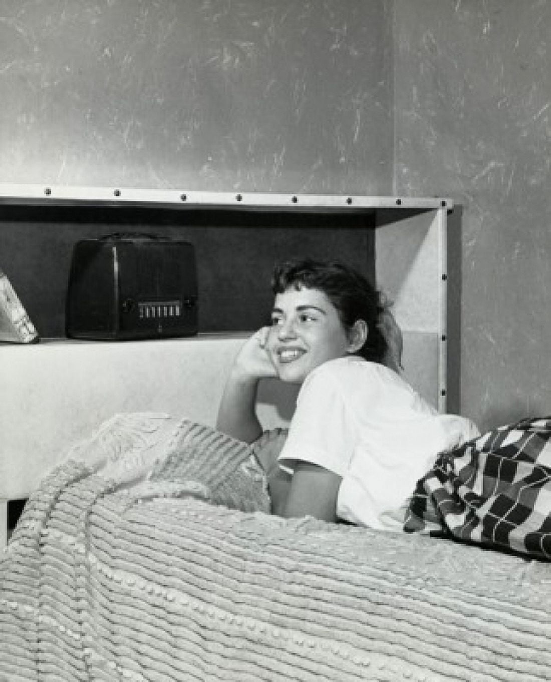 Side profile of a teenage girl lying on the bed and listening to the radio 1956 Canvas Art - (24 x 36)