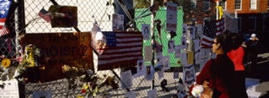 Side profile of a woman standing in front of chain-link fence at a memorial New York City New York State USA Canvas Art - Panoramic Images (36 x 13)