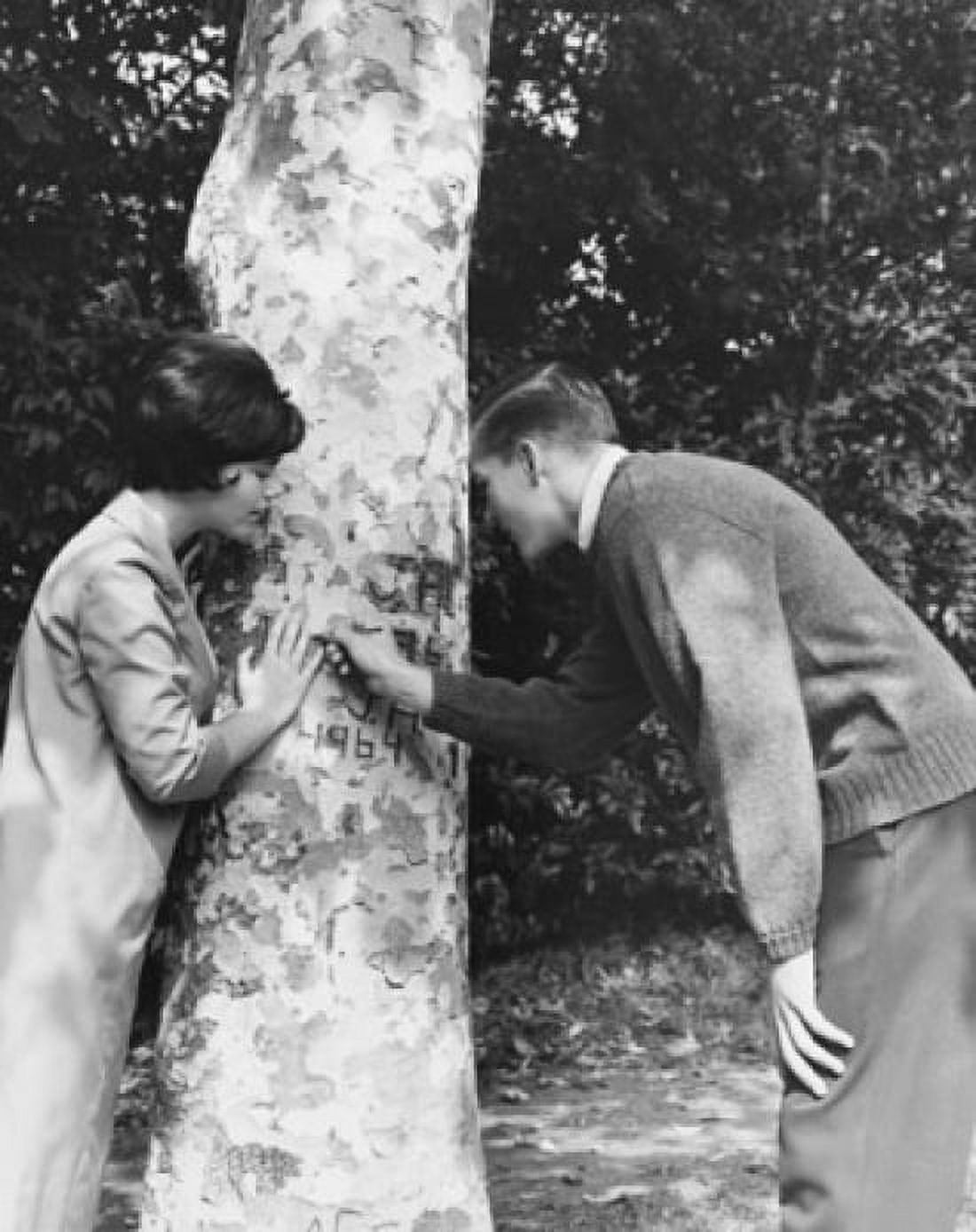 Side profile of a young couple carving their initials on a tree Canvas Art - (18 x 24)