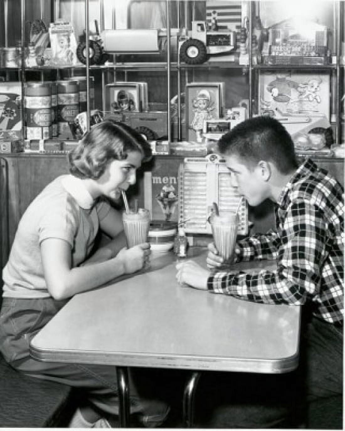 Side profile of a young couple drinking a milkshake in a restaurant 1954 Canvas Art - (18 x 24)