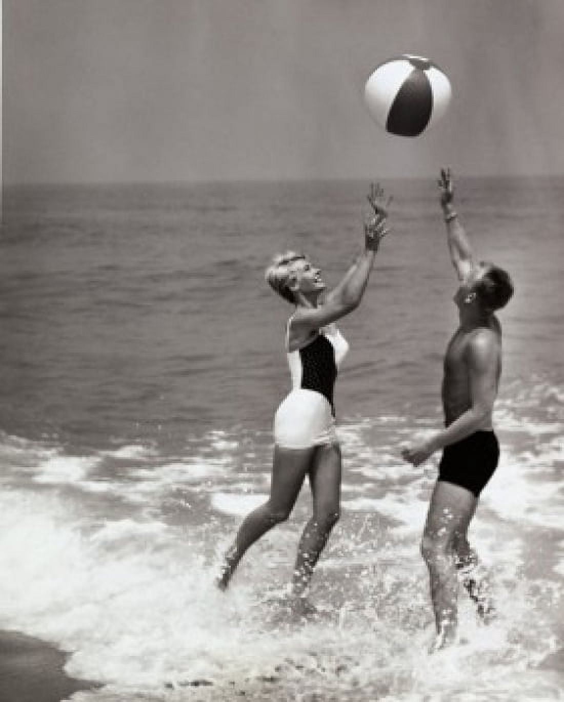 Side profile of a young couple playing with a beach ball on the beach Canvas Art - (18 x 24)