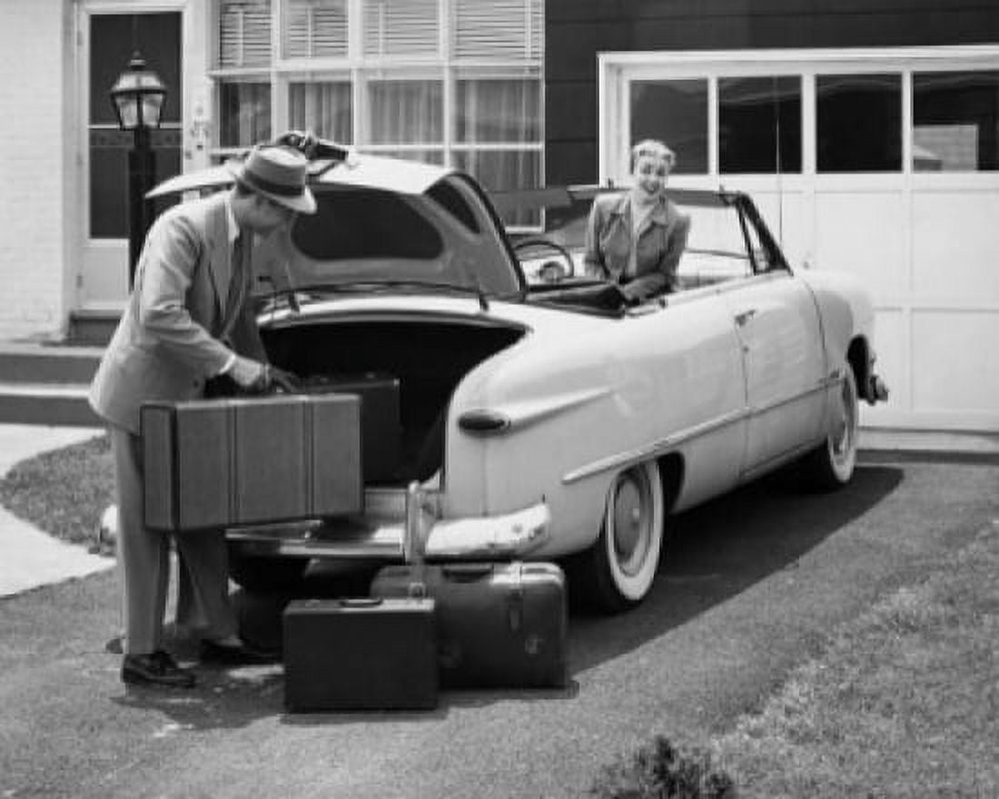 Side profile of a young man loading luggage into a car trunk Canvas Art - (24 x 36)