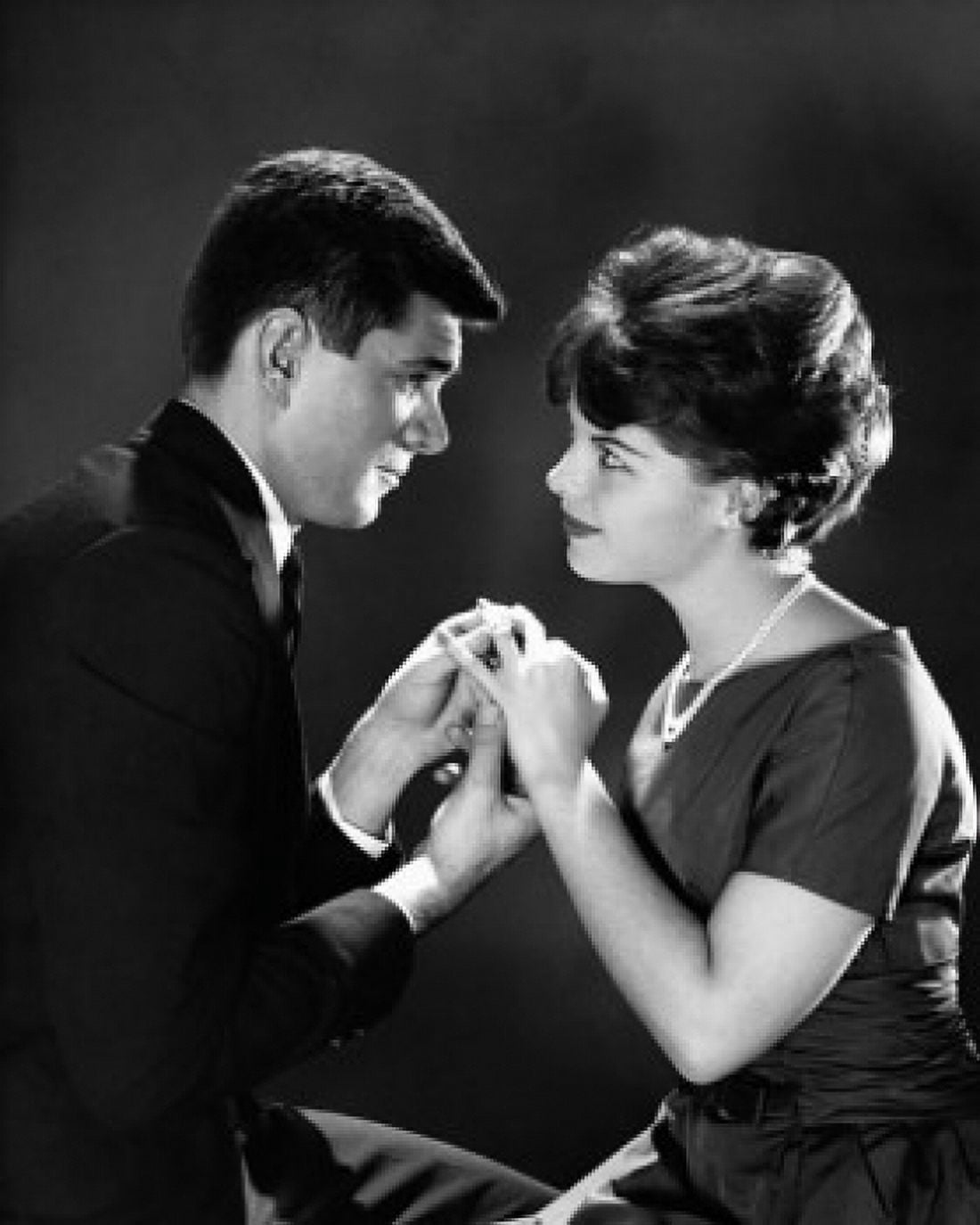 Side profile of a young man putting a ring on a young womans finger Canvas Art - (24 x 36)