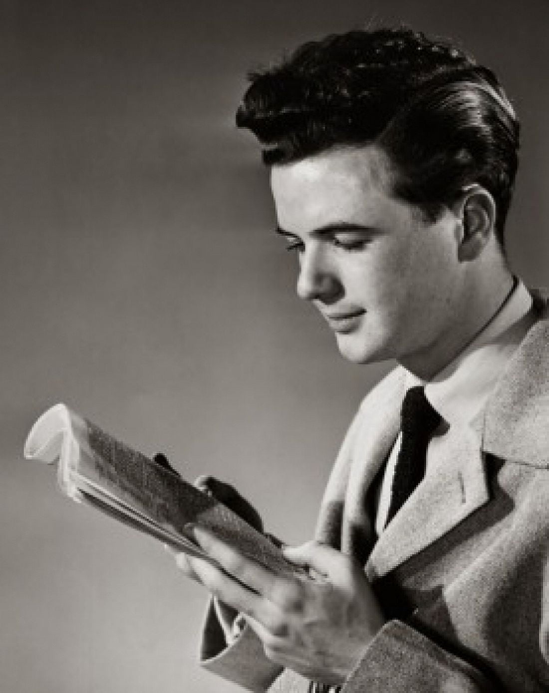 Side profile of a young man reading a newspaper Canvas Art - (24 x 36)