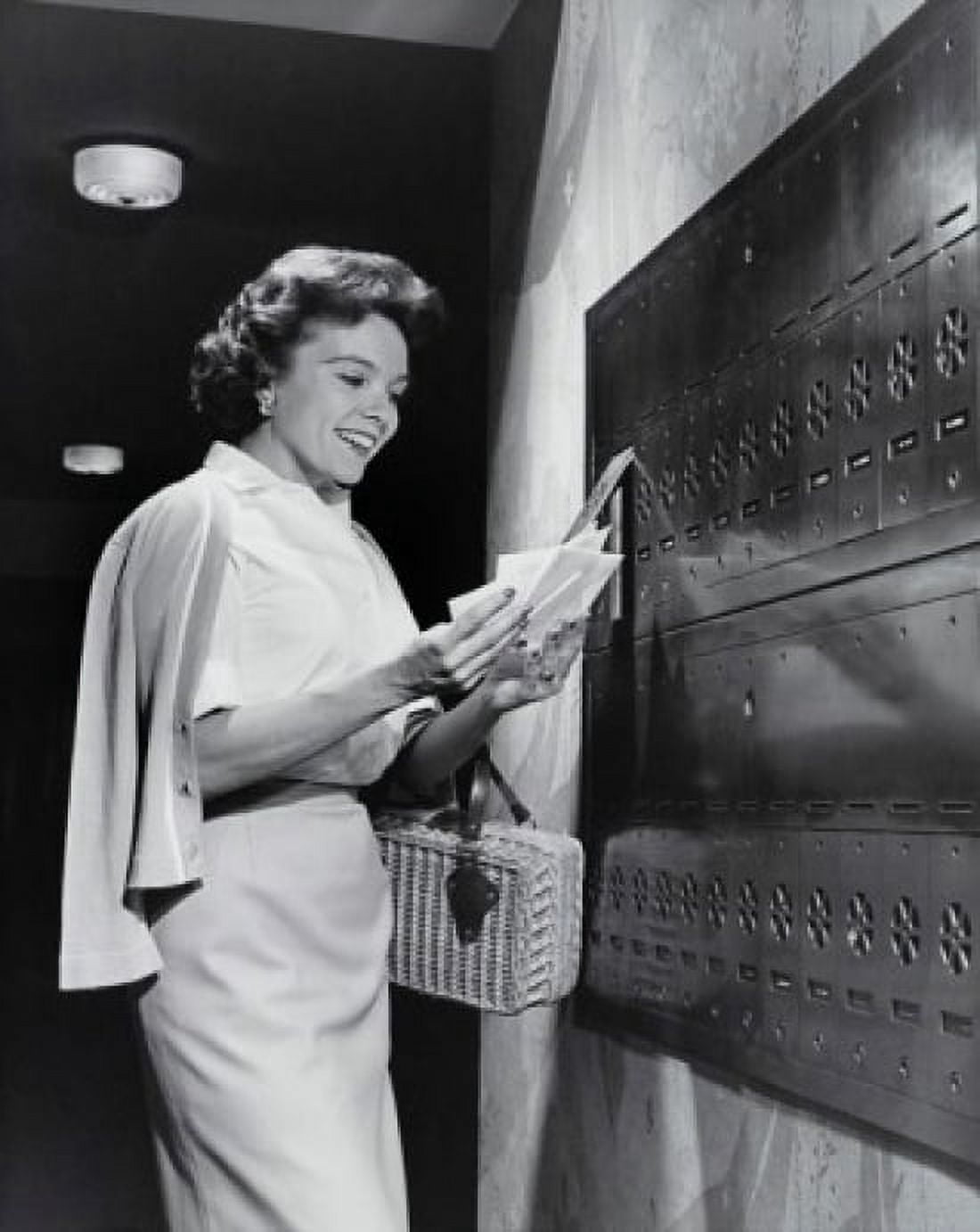 Side profile of a young woman collecting mail from a mailbox Canvas Art - (24 x 36)