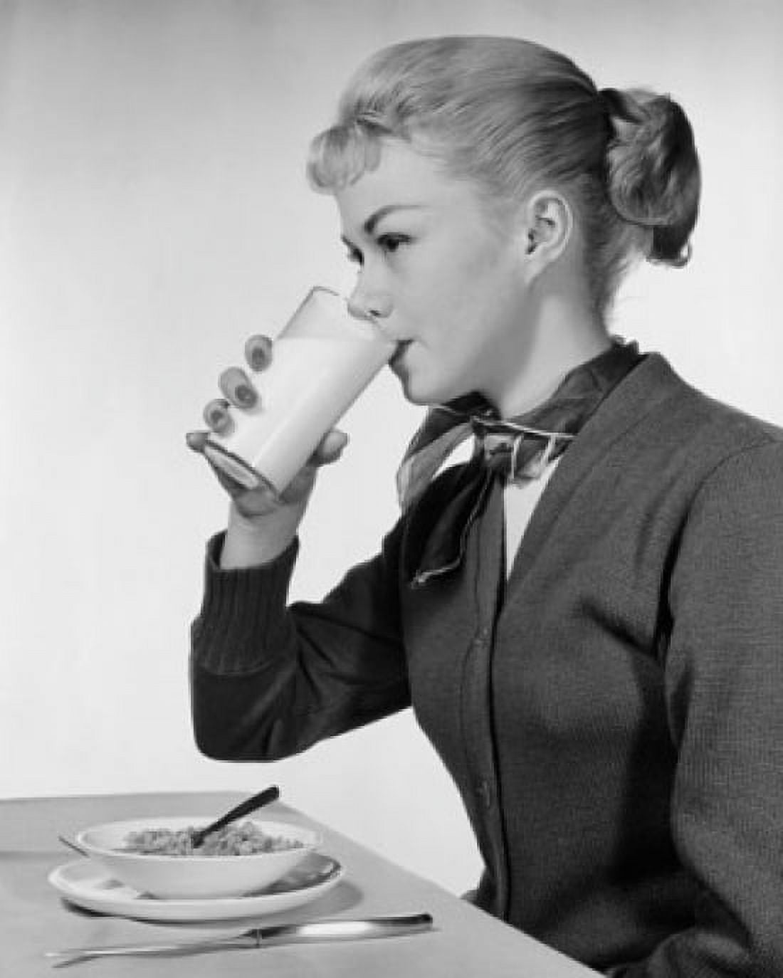 Side profile of a young woman drinking milk and eating cereal Canvas Art - (24 x 36)
