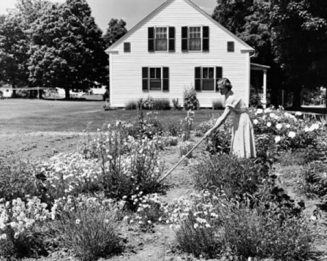 Side profile of a young woman gardening in front of a house Canvas Art - (24 x 36)