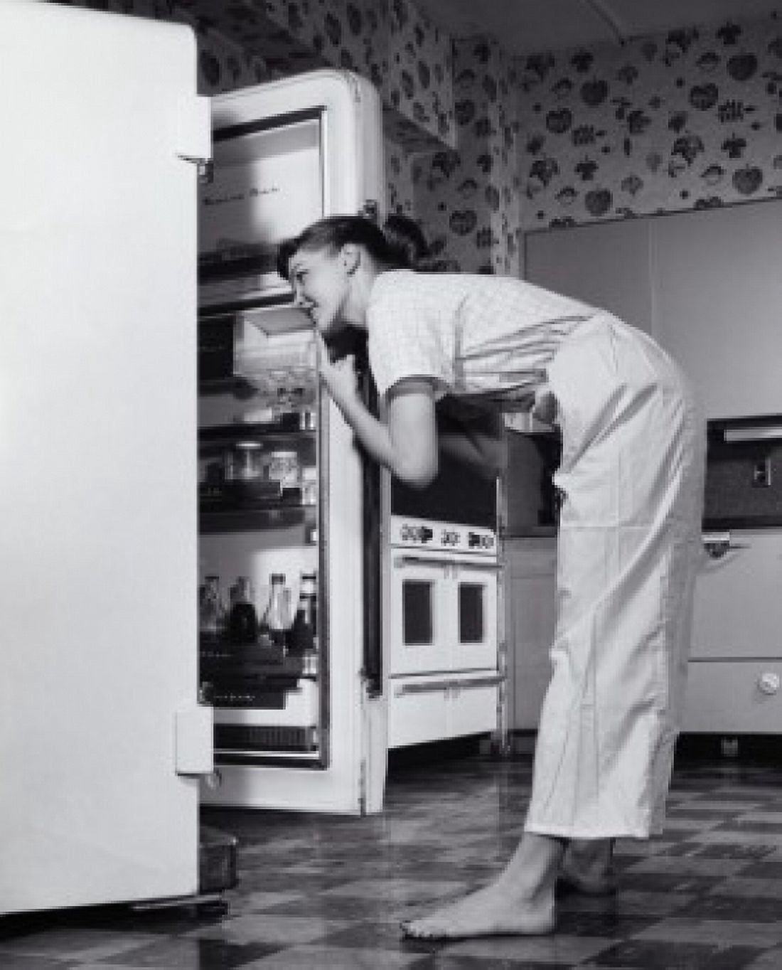 Side profile of a young woman looking in a refrigerator Canvas Art - (18 x 24)