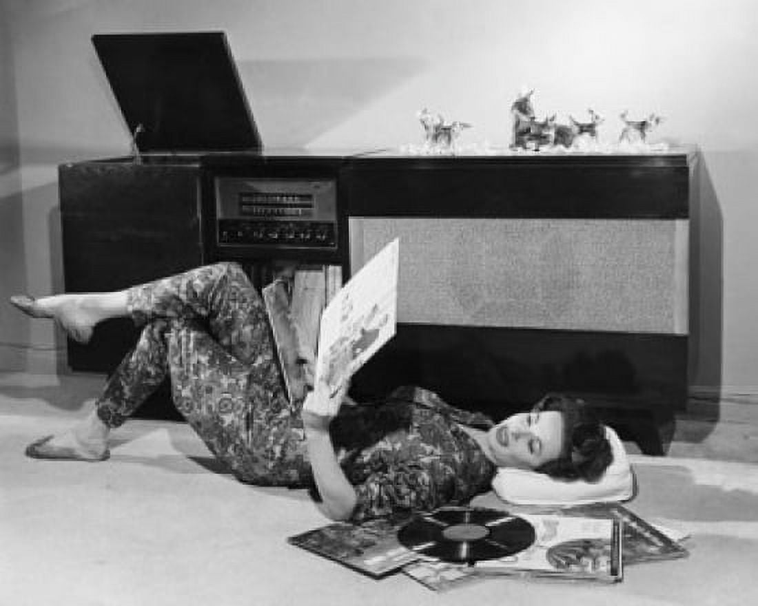Side profile of a young woman lying on the floor holding records Canvas Art - (18 x 24)