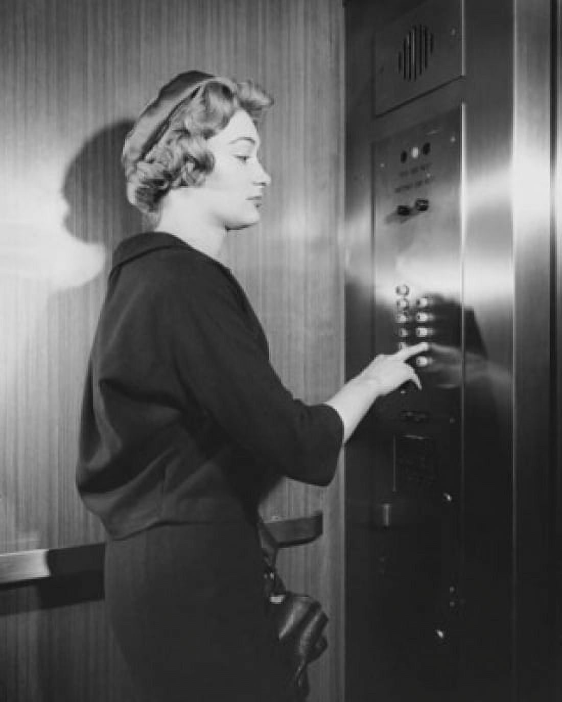 Side profile of a young woman operating an elevator Canvas Art - (18 x 24)