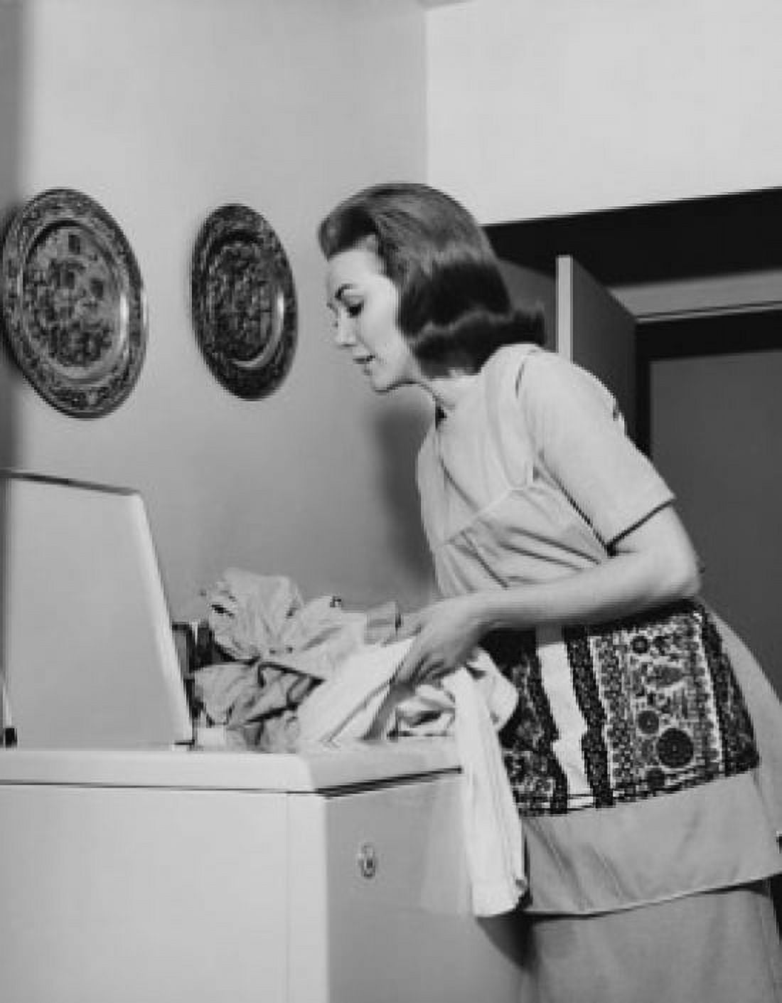 Side profile of a young woman putting clothes into a washing machine Canvas Art - (18 x 24)
