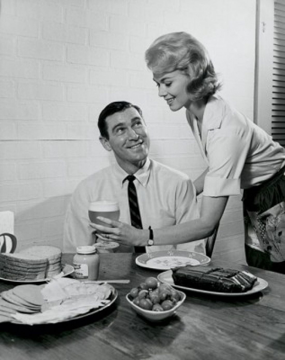 Side profile of a young woman serving food to a young man Canvas Art - (24 x 36)
