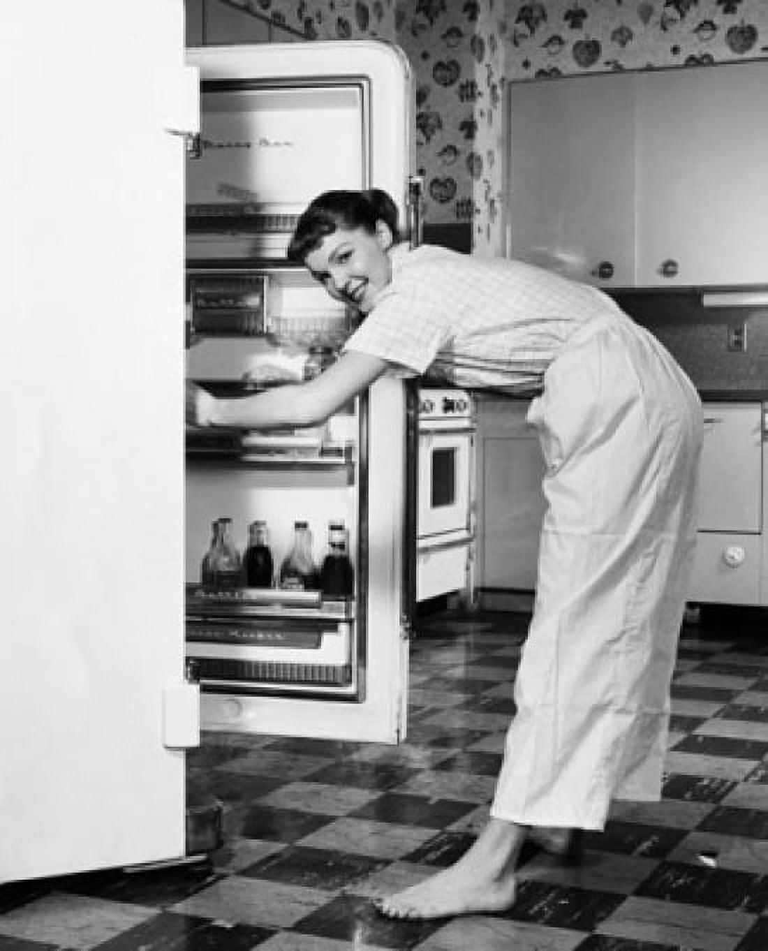 Side profile of a young woman standing in front of a refrigerator Canvas Art - (24 x 36)