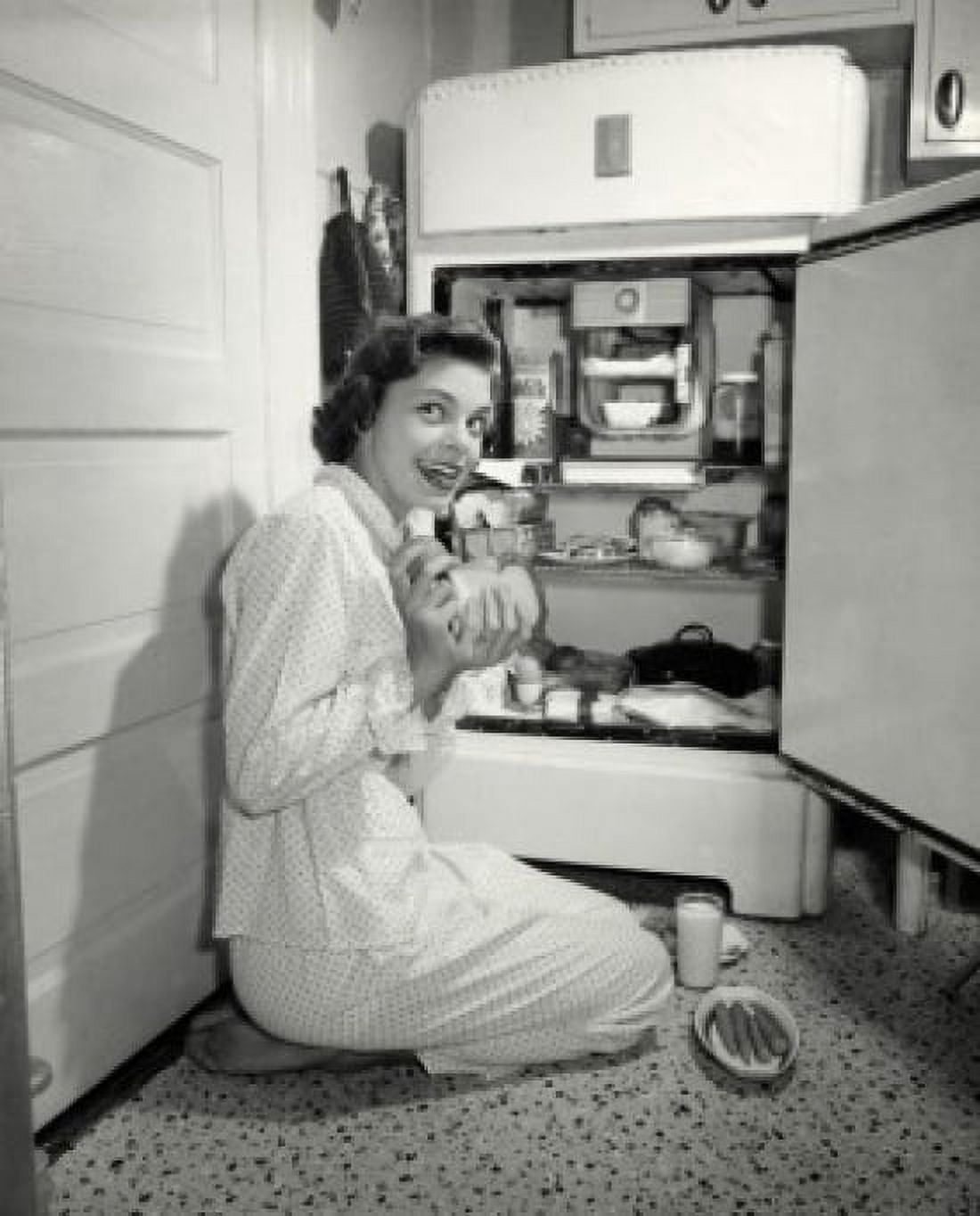 Side profile of a young woman taking out food from a refrigerator Canvas Art - (18 x 24)