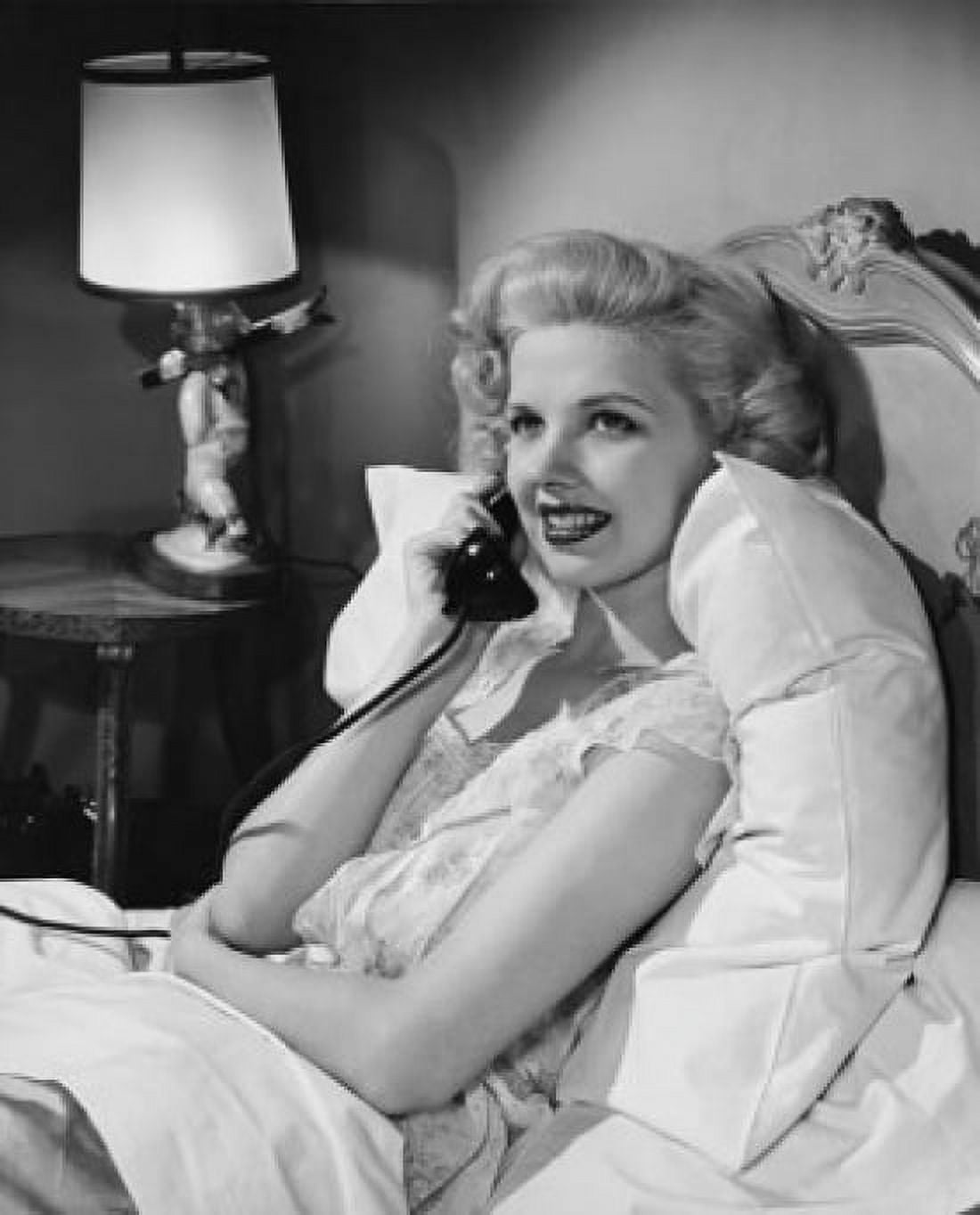 Side profile of a young woman talking on the telephone while lying in bed Canvas Art -  (18 x 24)
