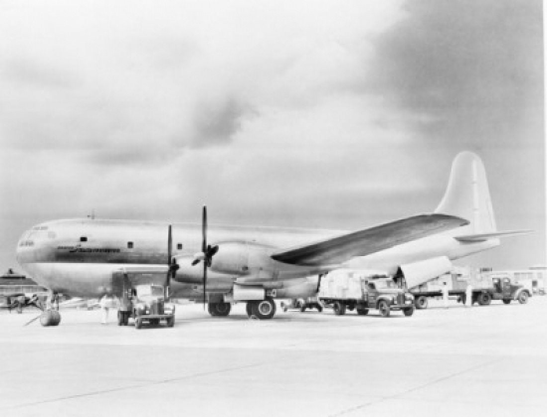 Side profile of an airplane at airport Canvas Art - (24 x 36)