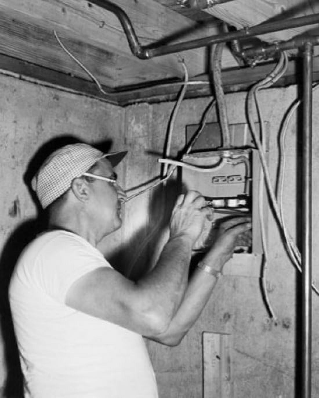 Side profile of an electrician installing a circuit board Canvas Art - (24 x 36)