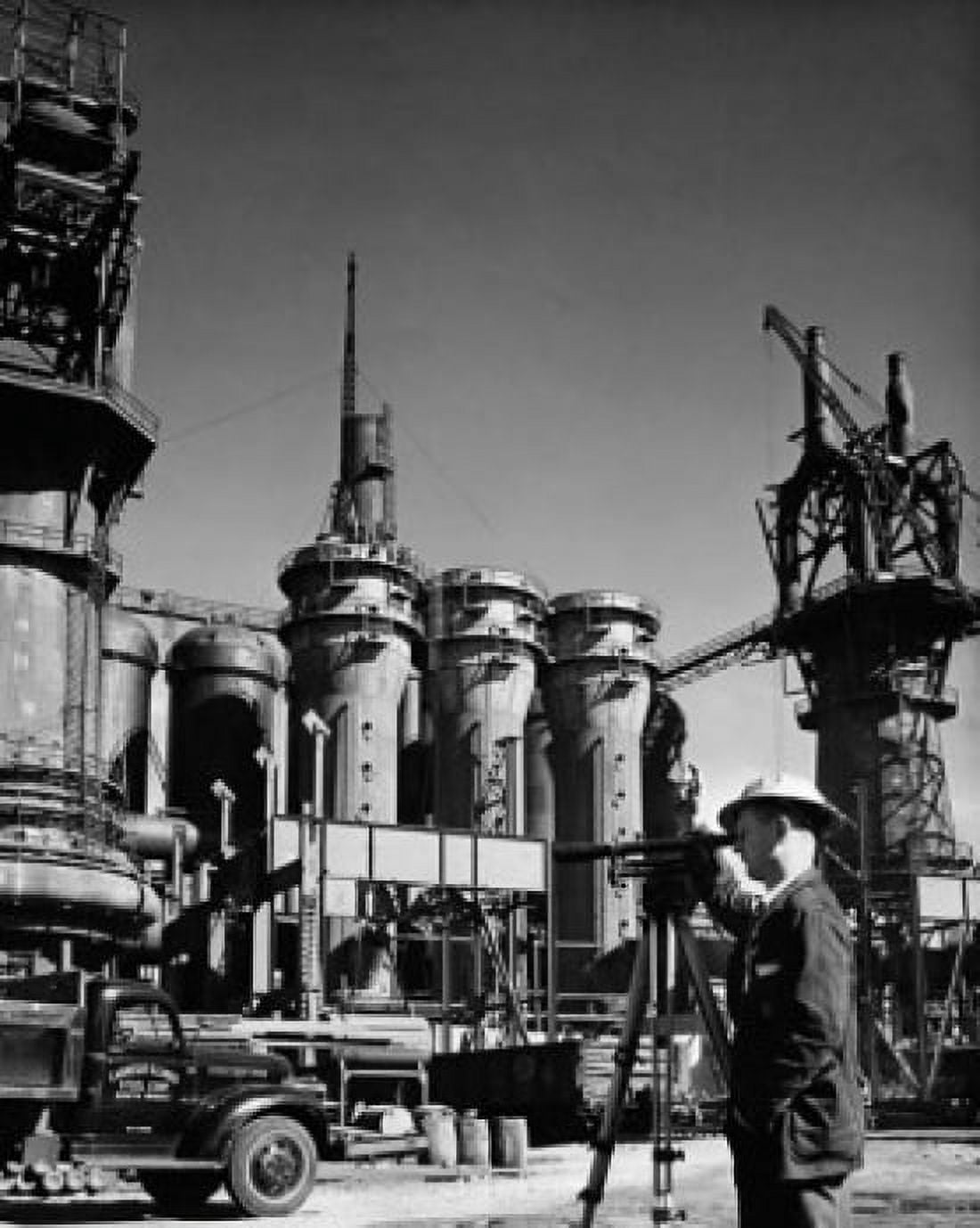 Side profile of an engineer looking through a theodolite at a steel factory Canvas Art - (18 x 24)