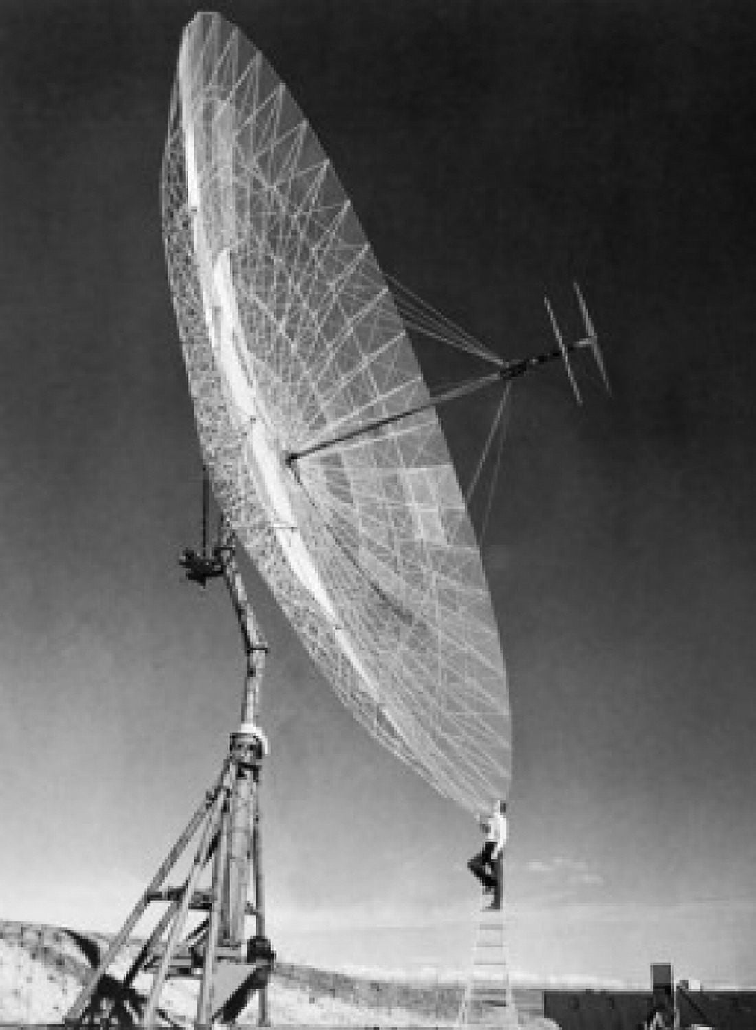 Side profile of an engineer standing on step ladder in front of a Parabolic antenna Canvas Art - (24 x 36)