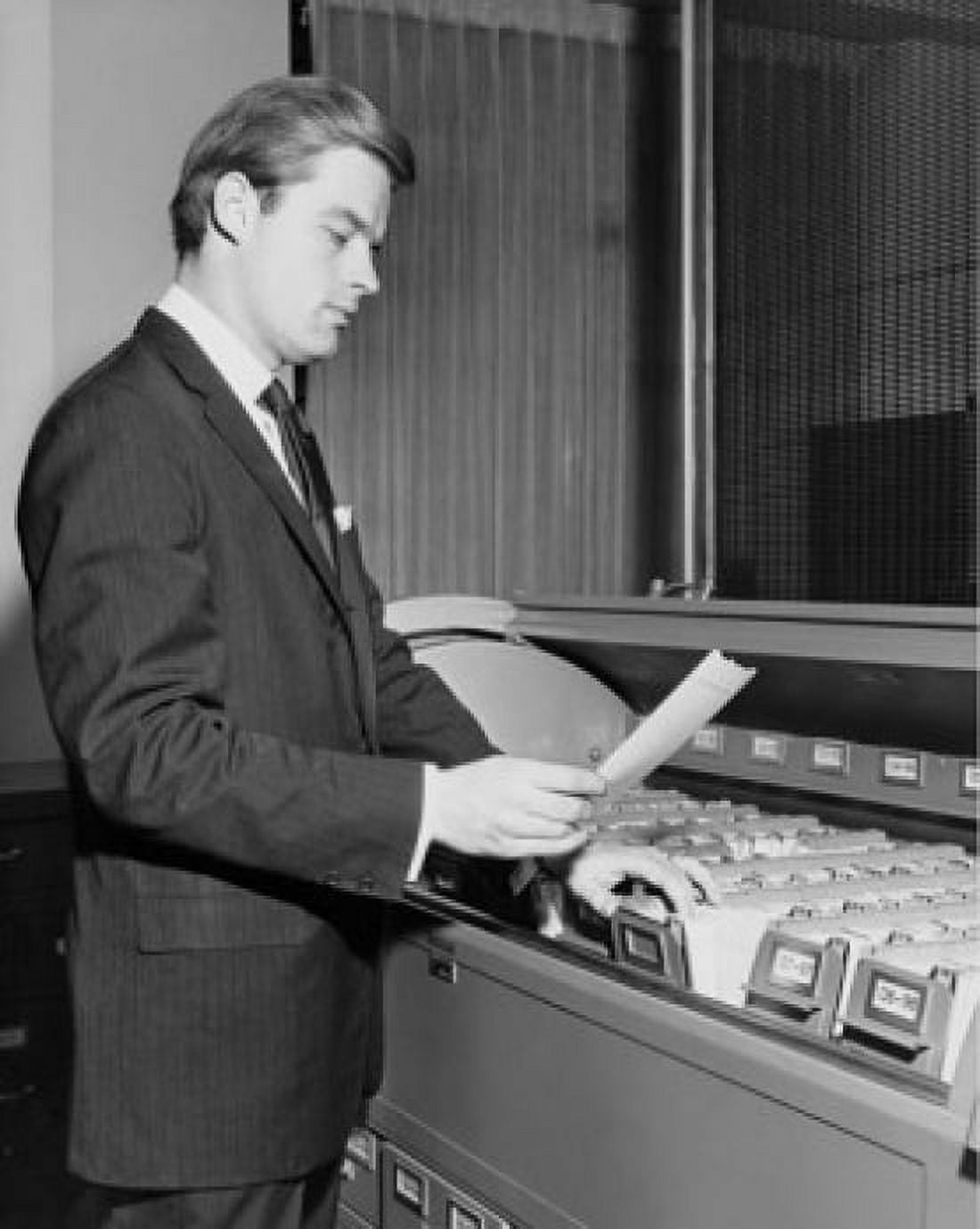 Side profile of businessman reading document beside filing cabinet Canvas Art - (24 x 36)
