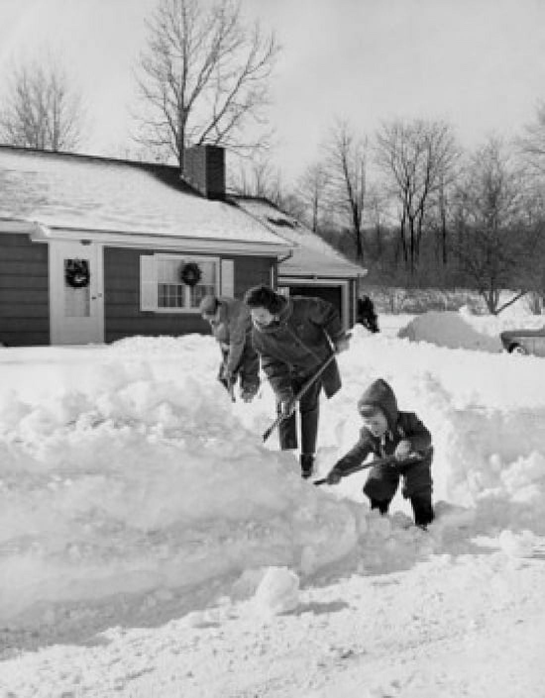 Side profile of parents and their son shoveling snow Canvas Art - (18 x 24)