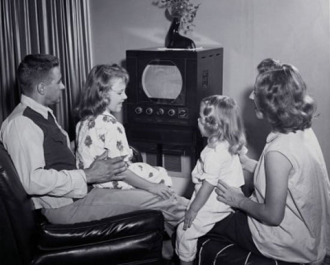 Side profile of parents with their two daughters watching television Canvas Art - (24 x 36)