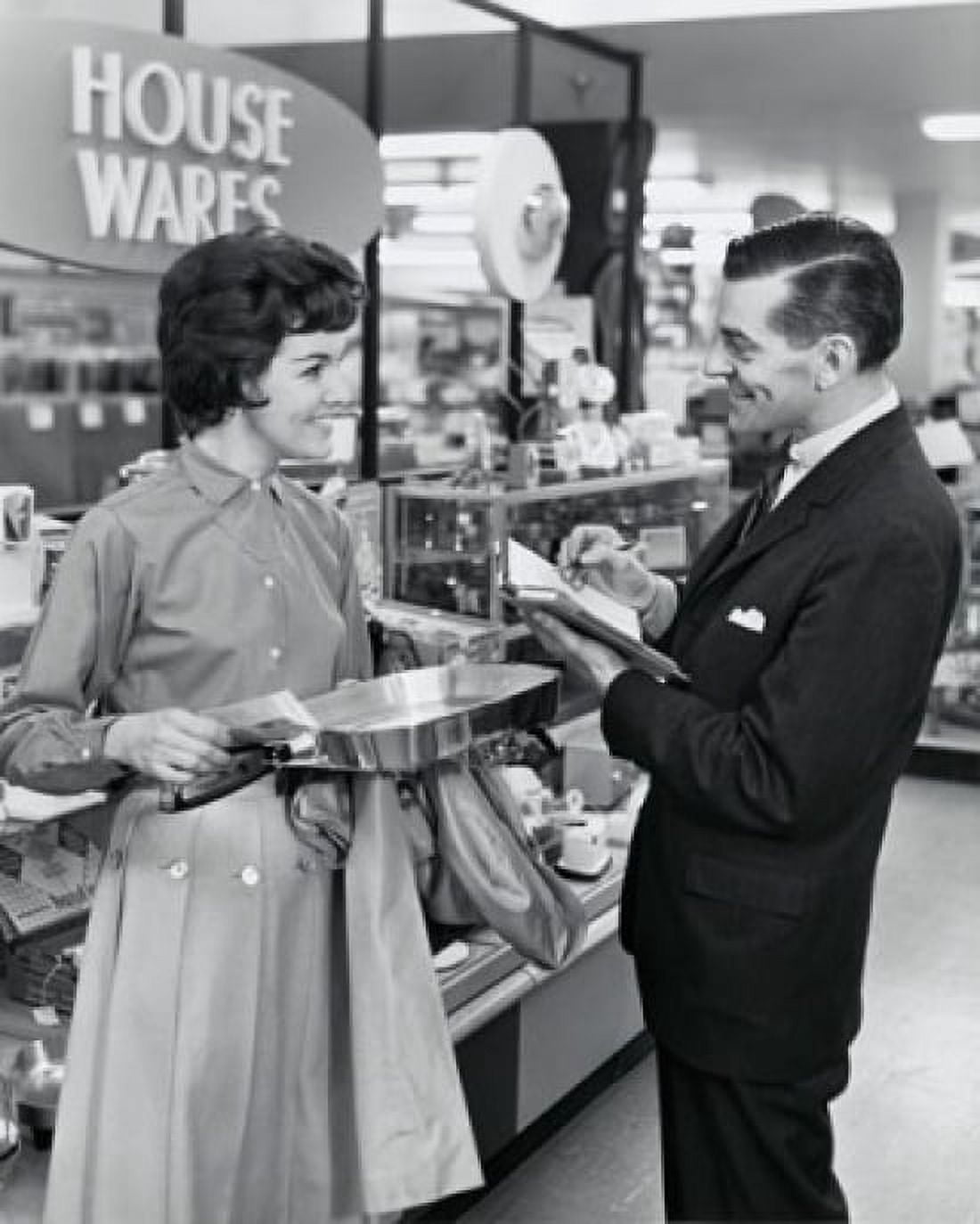 Side profile of salesman and female customer smiling in store Canvas Art - (18 x 24)