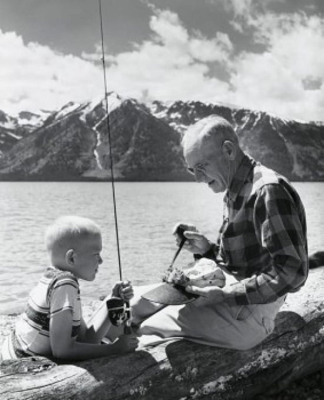 Side profile of senior man with grandson sitting at lakeside Canvas Art - (18 x 24)