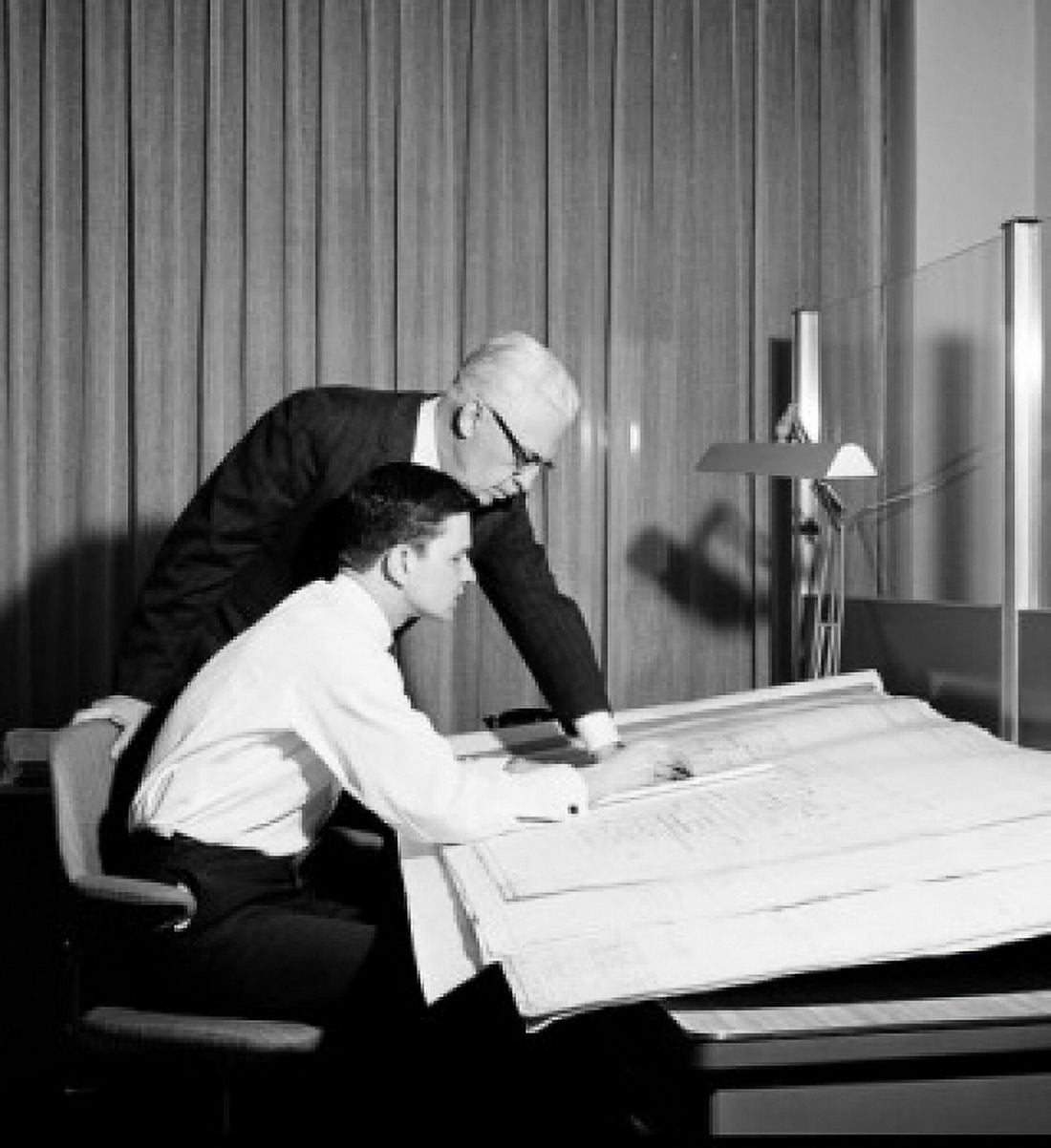 Side profile of two architects discussing on a blueprint Canvas Art - (18 x 24)