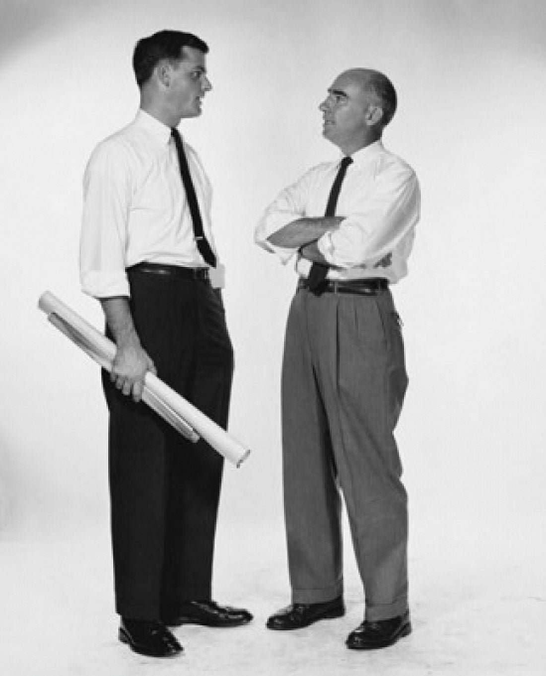 Side profile of two businessmen talking Canvas Art - (24 x 36)