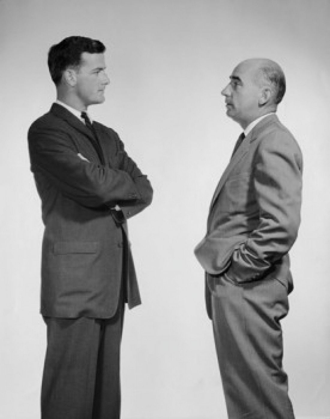 Side profile of two businessmen talking Canvas Art - (24 x 36)