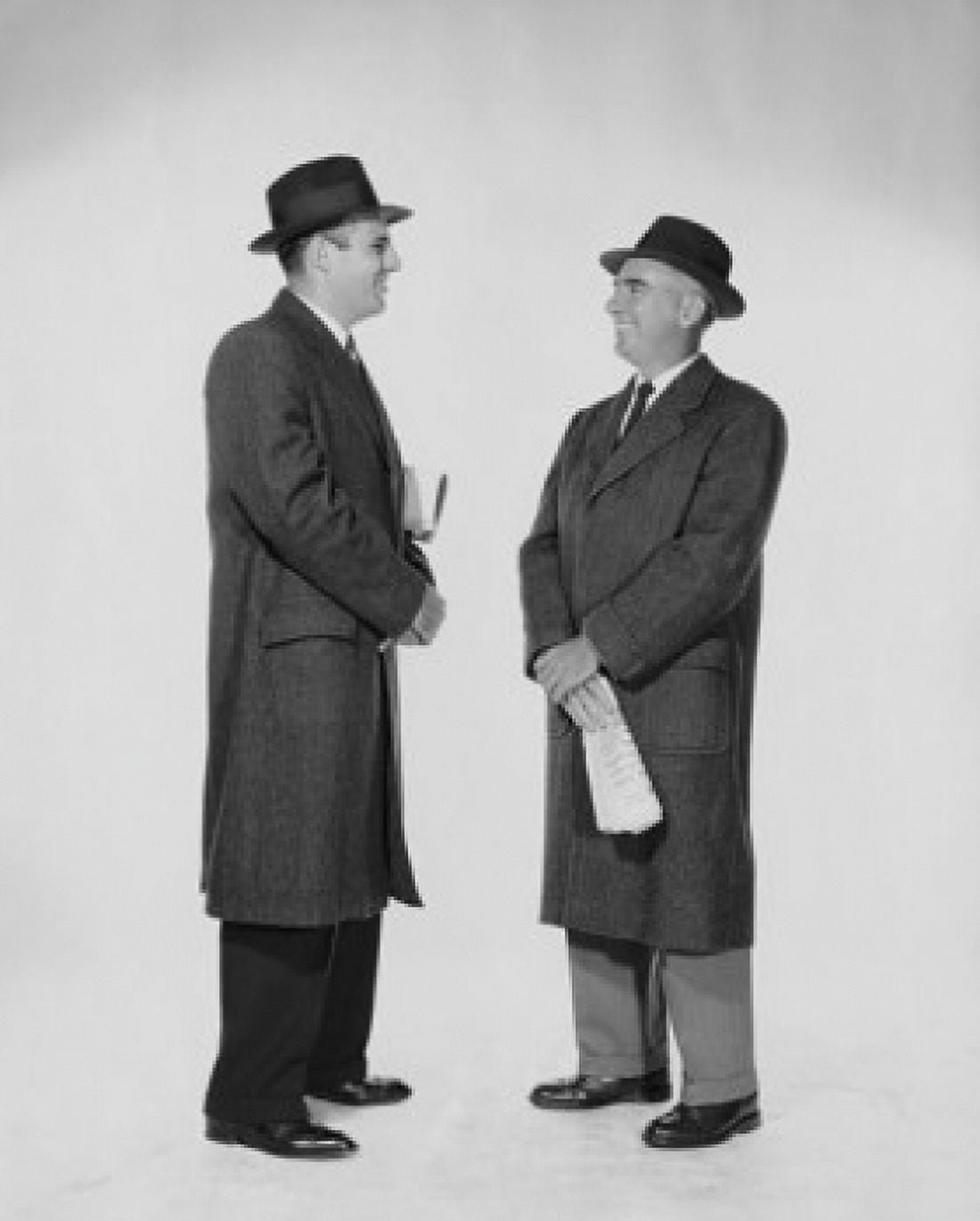 Side profile of two businessmen talking Canvas Art - (24 x 36)