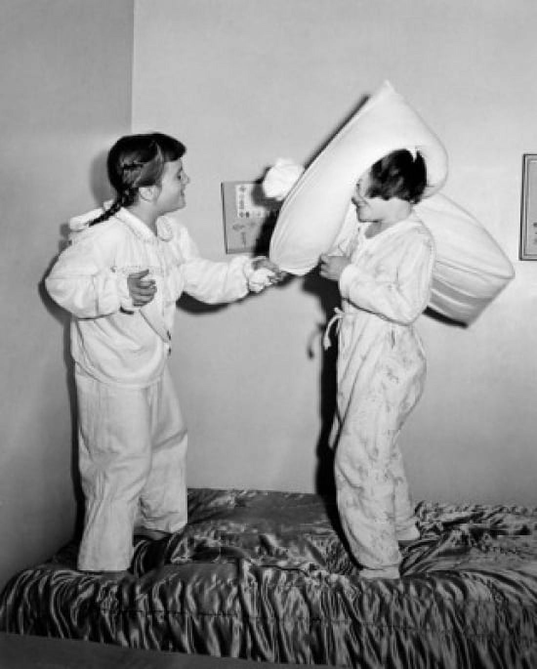 Side profile of two girls having a pillow fight Canvas Art - (24 x 36)