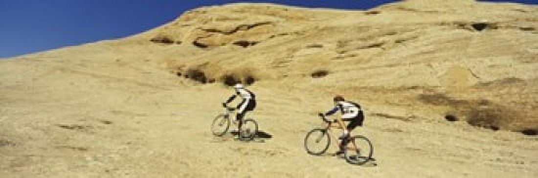 Side profile of two men mountain bilking on rocks Slickrock Trail Moab Utah USA Canvas Art - Panoramic Images (18 x 6)