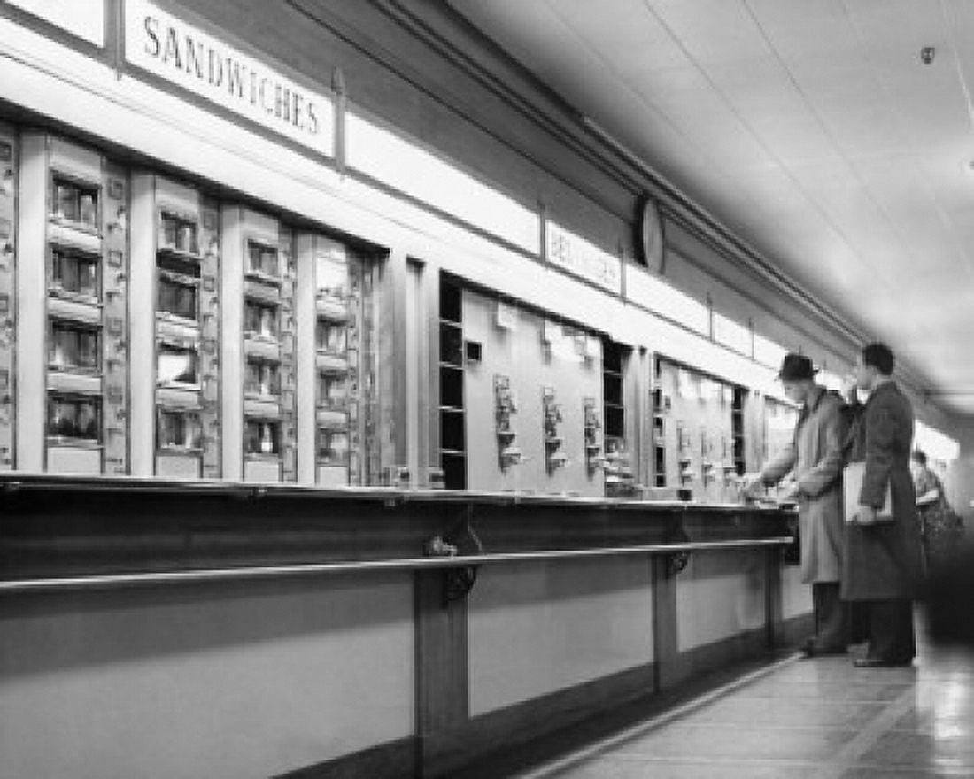 Side profile of two men standing at the counter of a restaurant Canvas Art - (24 x 36)
