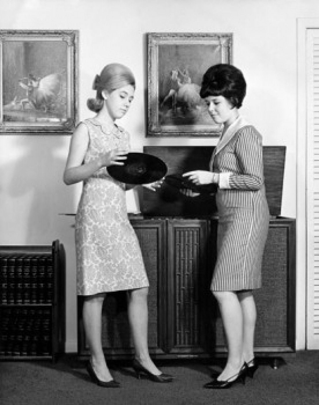 Side profile of two teenage girls looking at a record Canvas Art - (24 x 36)