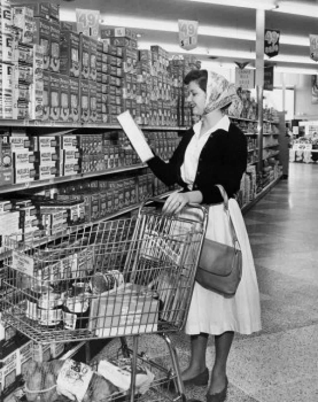 Side profile of young woman reading box in a grocery store Canvas Art - (18 x 24)