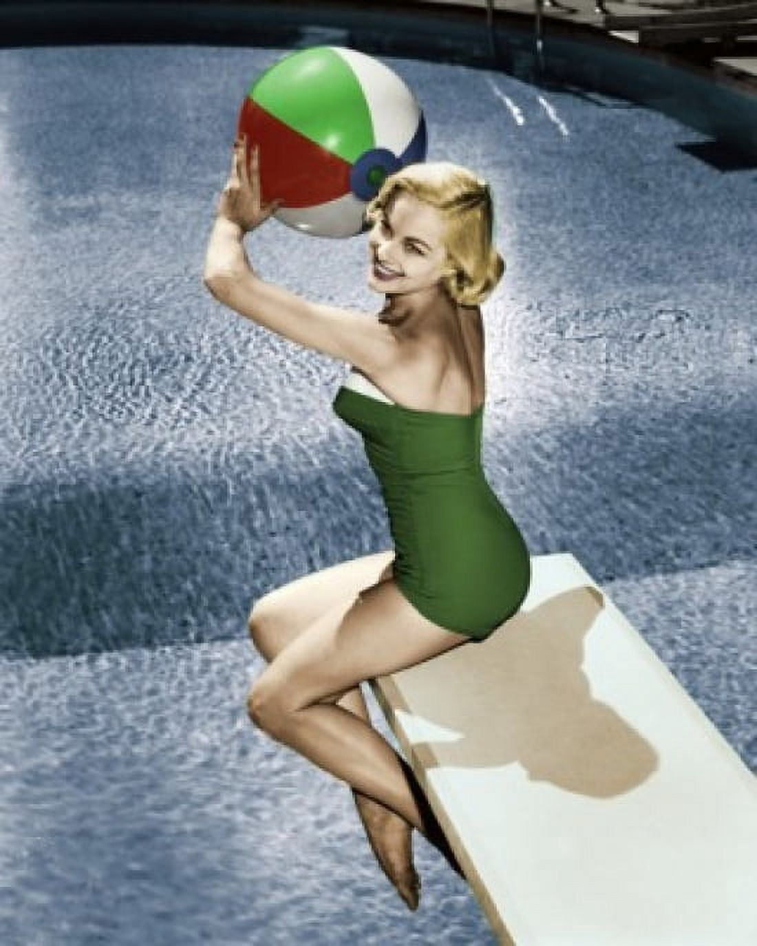 Side profile of young woman sitting on diving board holding beach ball Canvas Art - (18 x 24)