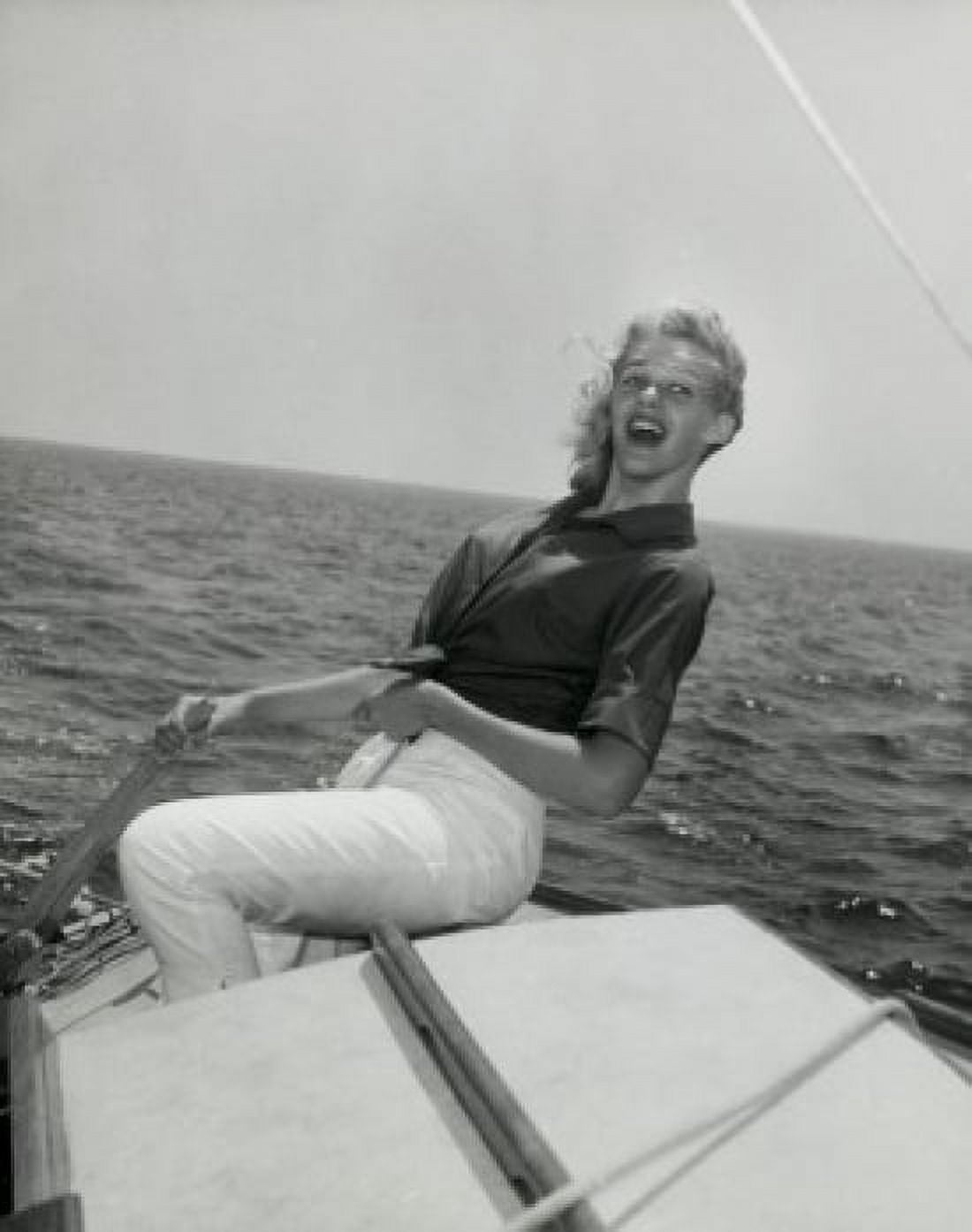 Side profile of young woman sitting on edge of boat and smiling Canvas Art - (24 x 36)