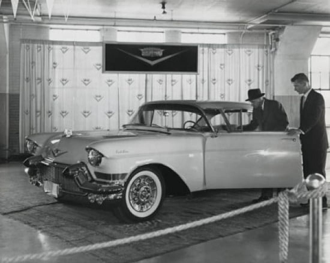 Side view of salesman showing car to customer in showroom Canvas Art - (18 x 24)