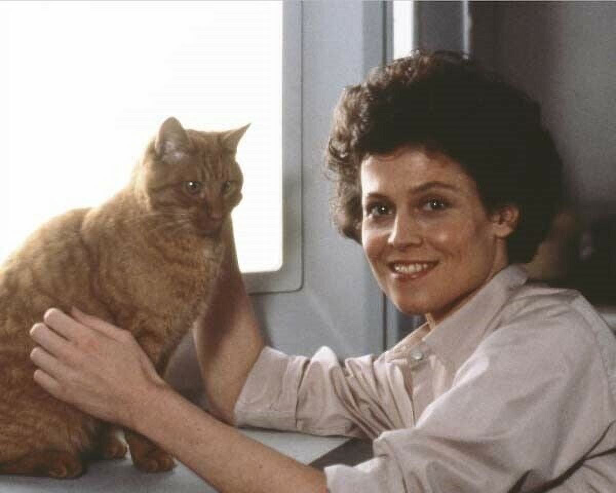 Sigourney Weaver smiling pose with ginger cat from Alien poster