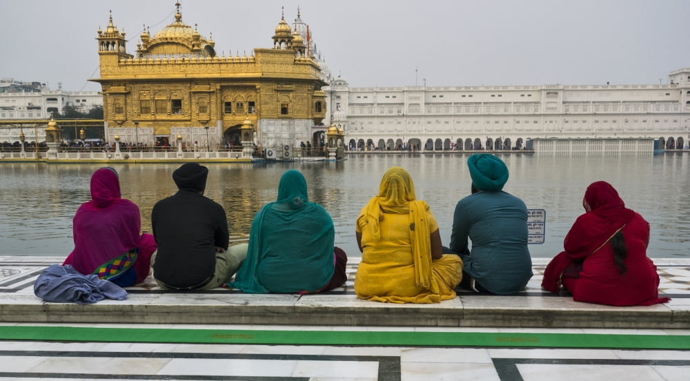 Sikh family sitting at the edge of pool at Golden Temple Amritsar Punjab India Canvas Art - Panoramic Images (27 x 9)