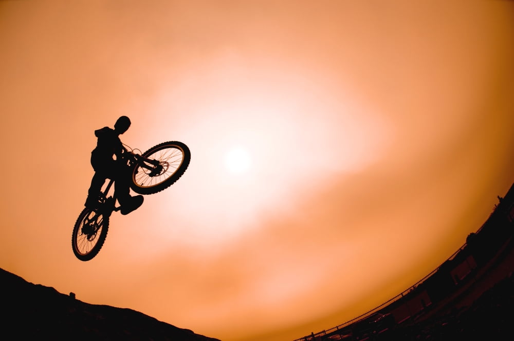 Silhouette Of Stunt Cyclist Canvas Art - Corey Hochachka Design Pics (34 x 22)