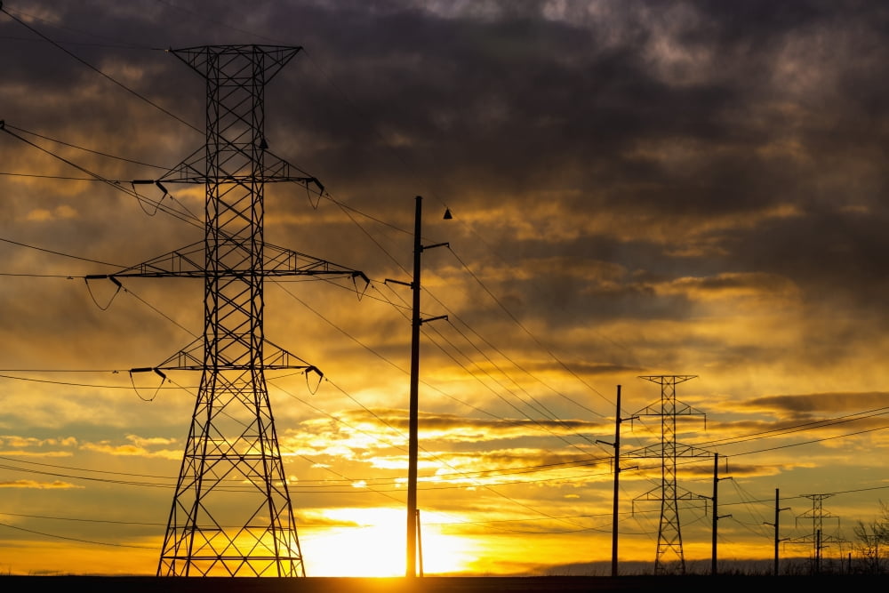 Silhouette of large metal powerline towers with colourful clouds and sun Calgary Alberta Canada Canvas Art - Michael Interisano Design Pics (19 x 12)