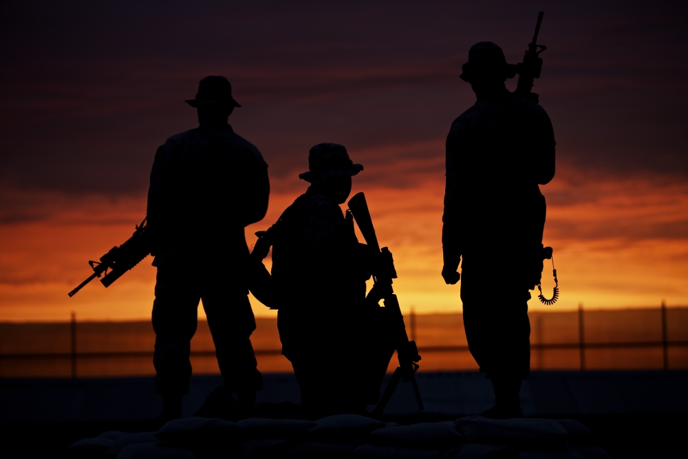 Silhouette of US Marines on a bunker at sunset in Afghanistan Canvas Art - Terry MooreStocktrek Images (18 x 12)