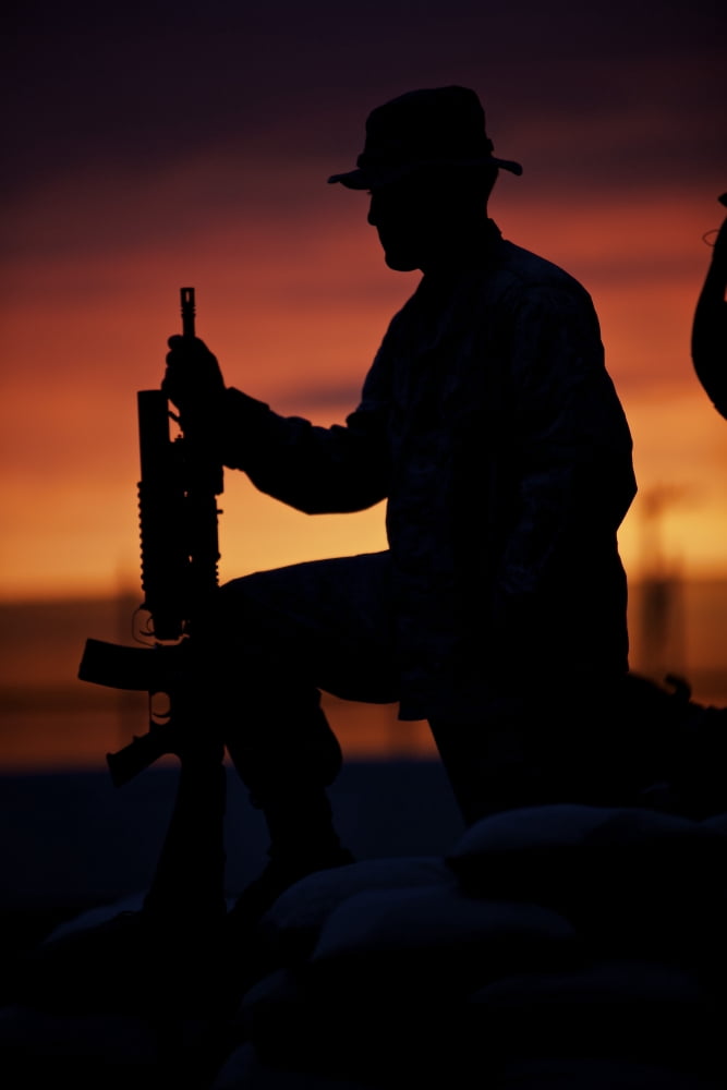 Silhouette of a US Marine on a bunker at sunset in Afghanistan Canvas Art - Terry MooreStocktrek Images (12 x 18)