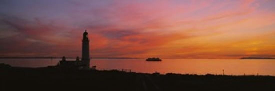 Silhouette of a lighthouse at sunset Scotland Canvas Art - Panoramic Images (18 x 6)