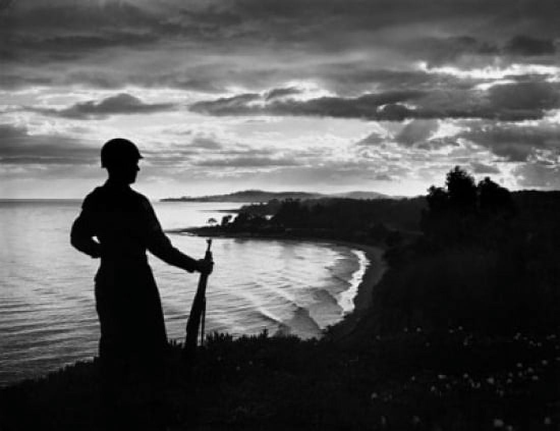 Silhouette of an army soldier standing with gun at dusk Canvas Art - (24 x 36)