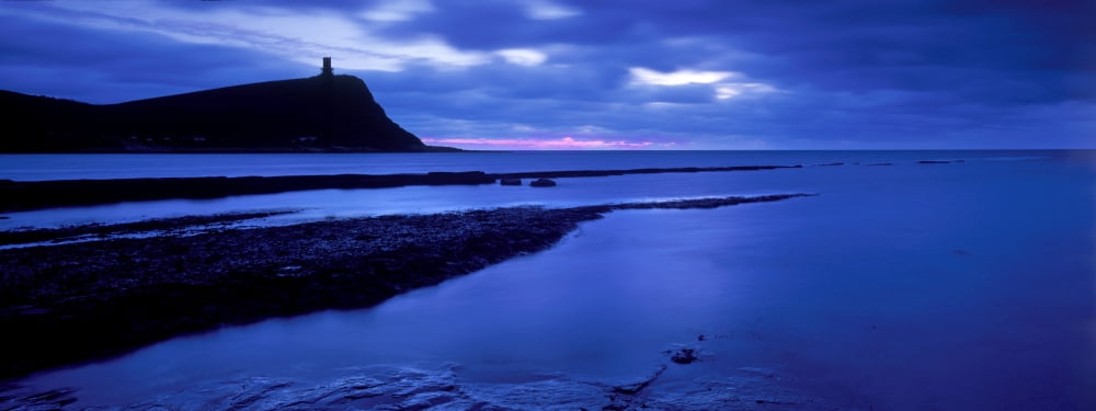 Silhouette of an island in the sea Eype Bay Dorset England Canvas Art - Panoramic Images (27 x 9)