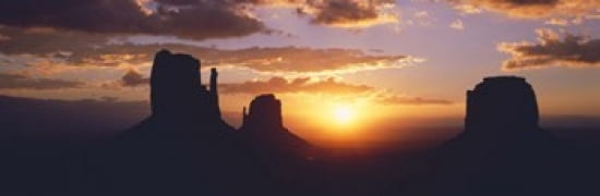 Silhouette of buttes at sunset The Mittens Monument Valley Tribal Park Monument Valley Utah USA Canvas Art - Panoramic Images (36 x 12)